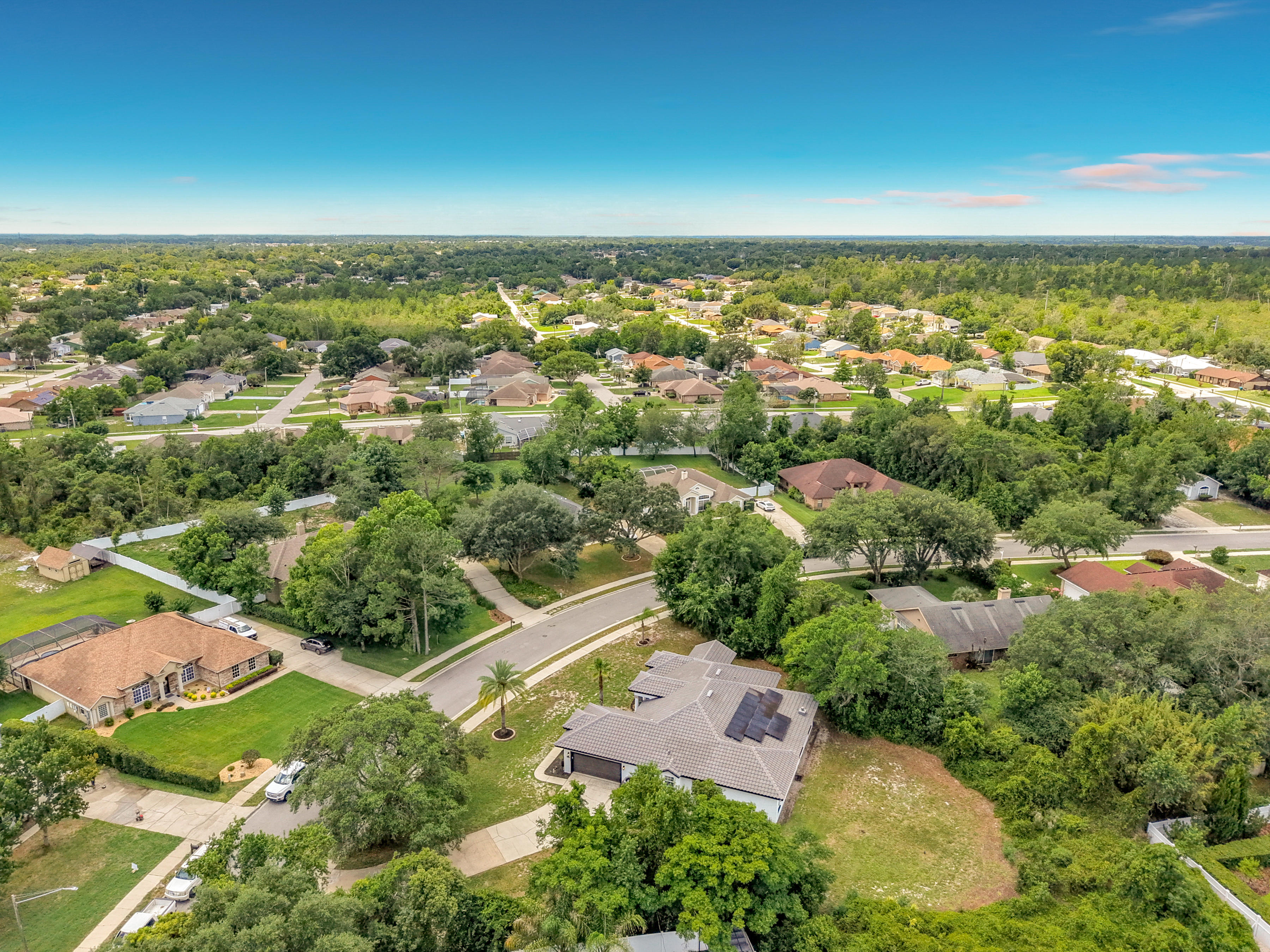 Drone aerial view showing solar panels and corner lot layout